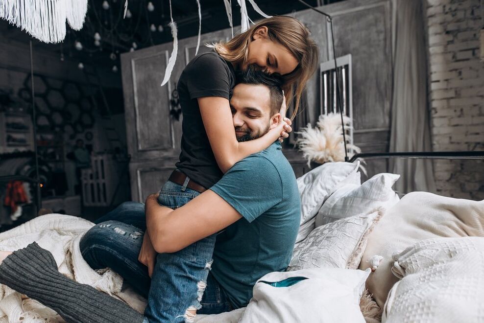 woman hugging man who boosts strength